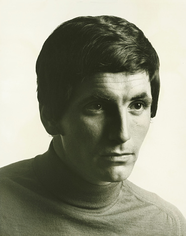 Vintage image portrait, headshot studio photo of a pensive man looking away