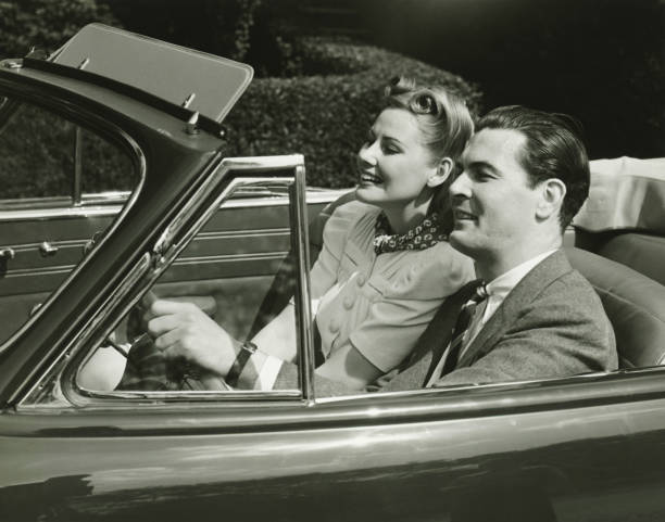 Elegant couple riding in in convertible car, (B&W)  convertible photos stock pictures, royalty-free photos & images