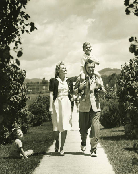 Family with two children (4-5) on walk, (B&W) 20th century photos stock pictures, royalty-free photos & images