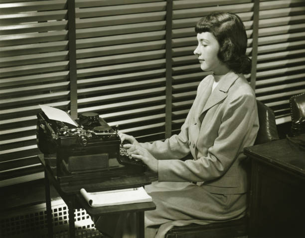 Secretary typing on typewriter in office, (B&W)  typewriter photos stock pictures, royalty-free photos & images