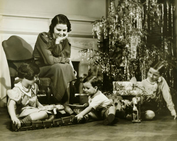 母 3 人の子供が遊ぶながらクリスマスツリー、(b &w - b boy ストックフォトと画像
