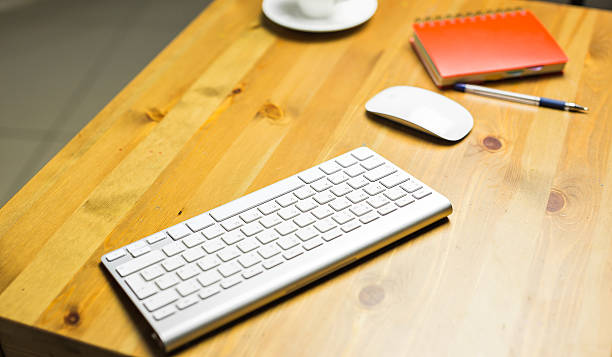 istock Desk accessories desktop, keyboard, computer mouse on wooden oak table 576546458