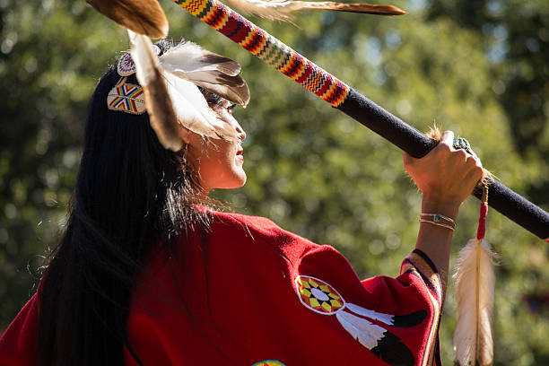 Woman dancing at the Kiowa Blackleggings Warrior Society Pow-wow. Anadarko, Oklahoma, U.S.A. - October 11, 2015: Woman dancing at the Kiowa Blackleggings Warrior Society Pow-wow. kiowa stock pictures, royalty-free photos & images