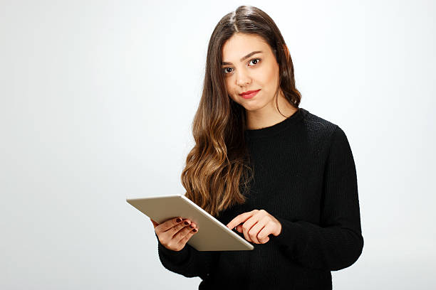 istock Happy young woman with digital tablet 576547792