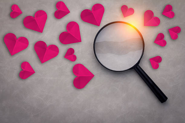 istock red heart paper with magnifying glass 576548286