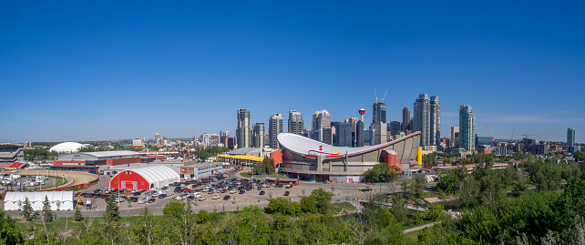 Calgary, Canada - June 5, 2016: Calgary's skyline with the Scotiabank Saddledome in the foreground June 5, 2016 in Calgary, Alberta. The Saddledome is home to the Calgary Flames NHL club.