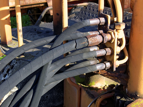 old black tubes of a construction machine