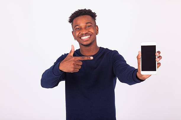istock Young African American man pointing his  smartphone screen - Bla 576555614