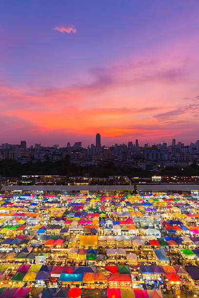 istock Aerial view multiple colour weekend market roof top 576555950