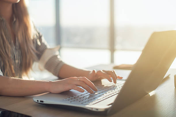 istock Female writer typing using laptop keyboard at her workplace in 576556938