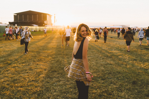 Young Caucasian girl has fun on music festival