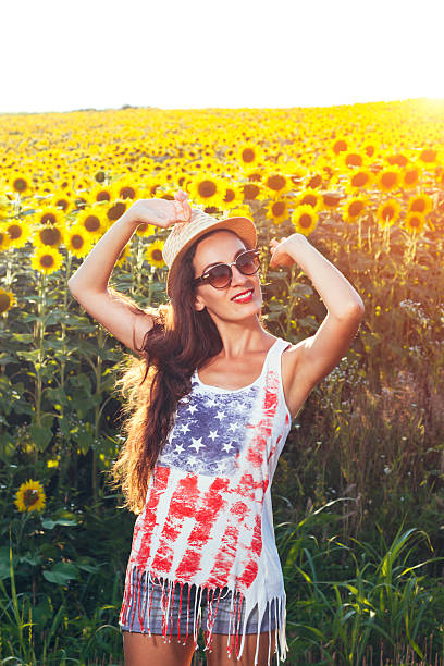 istock Young woman in sunflower field 576558928