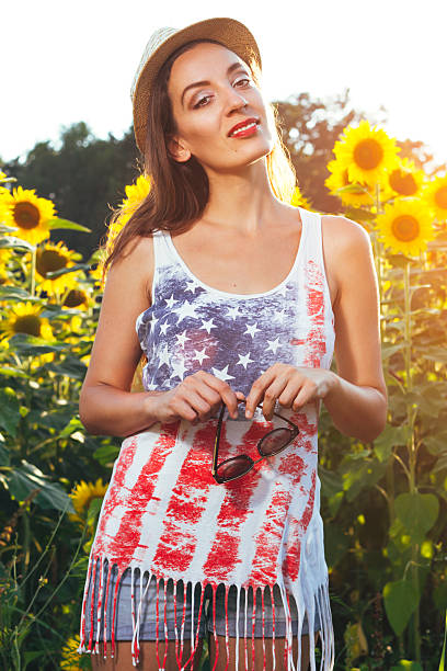 istock Young woman in sunflower field 576559354