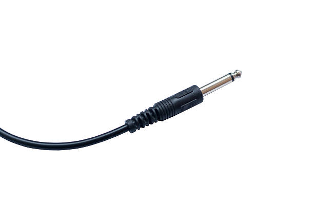 istock Guitar audio jack with black cable isolated on white background 576560766