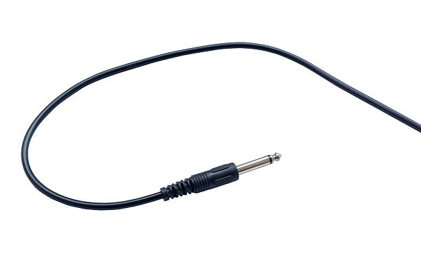 istock Guitar audio jack with black cable isolated on white background 576560804