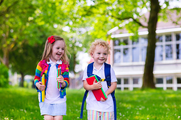 istock Adorable kids on first school day 576561296