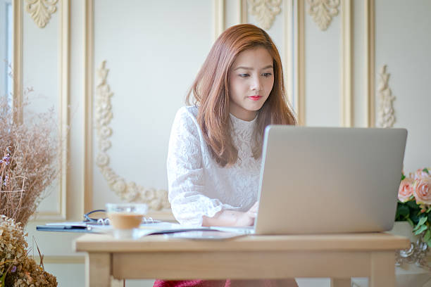 istock Beautiful business woman using a laptop 576563428
