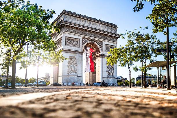 Paris city view - Arc de Triomphe View of Paris Arc de Triomphe at night during the 14th of July, National Holiday. avenue des champs elysees photos stock pictures, royalty-free photos & images
