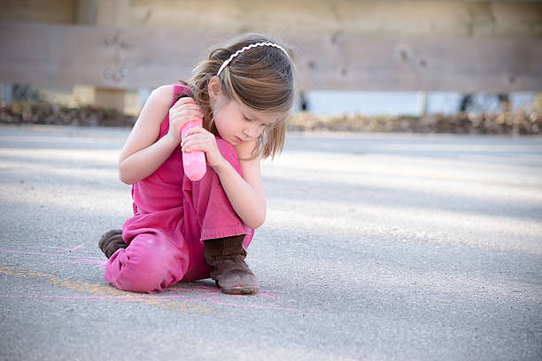 istock Little girl with jumbo chalk 576563652