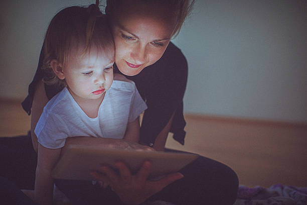 istock Mother and daughter watching digital tablet together. 576565988