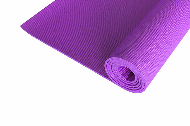 istock Purple yoga mat isolated on white. 576568380