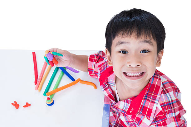 istock Child show his works from clay, on white background. 576569886