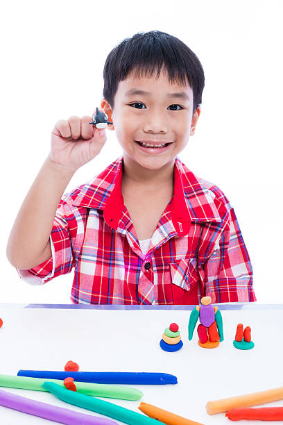 istock Child show his works from clay, on white background. 576570178