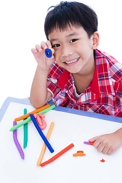 istock Child show his works from clay, on white background. 576570410