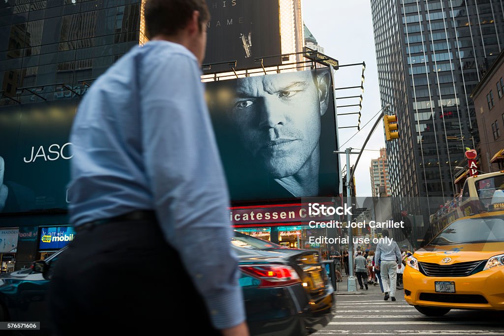 Jason Bourne movie billboard at New York City's Times Square New York City, USA - July 13, 2016: An advertisement for Jason Bourne, an upcoming film starring Matt Damon, is posted in New York City's Times Square. Pedestrians and traffic are on the street. Matt Damon Stock Photo