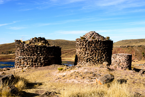 Sillustani is a pre-Incan burial ground on the shores of Lake Umayo near Puno in Peru.  The tombs, which are built above ground in tower-like structures called chullpas, are the vestiges of the Colla people, Aymara who were conquered by the Inca in the 15th century. The structures housed the remains of complete family groups, although they were probably limited to nobility.