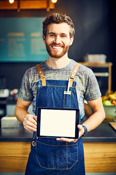 istock Smiling barista with blank digital tablet 576573710