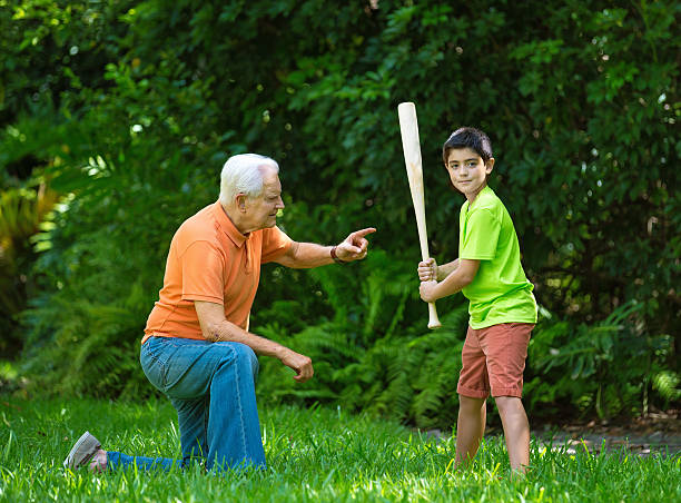 Practice session with grandpa Learning batting techniques old baseball stock pictures, royalty-free photos & images