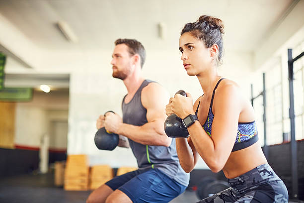 istock Determined female athlete with instructor exercising in health c 576576310