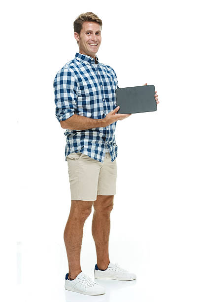 istock Smiling casual man showing tablet 576576688
