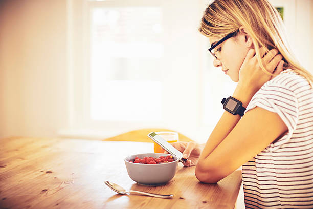 istock Side view of blogger with smart phone and breakfast 576577246