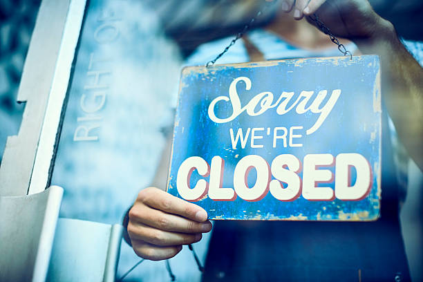 istock Waiter hanging closed sign on glass window 576577510