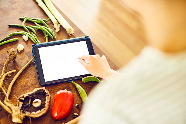 istock Cropped image of female touching blank screen of tablet computer 576577582