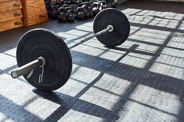 istock High angle view of black barbell on floor in gym 576578362