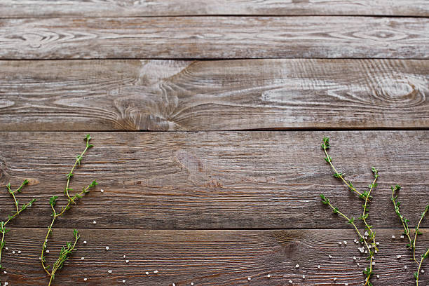 istock Wooden background with rosemary herbs, free space 576580884