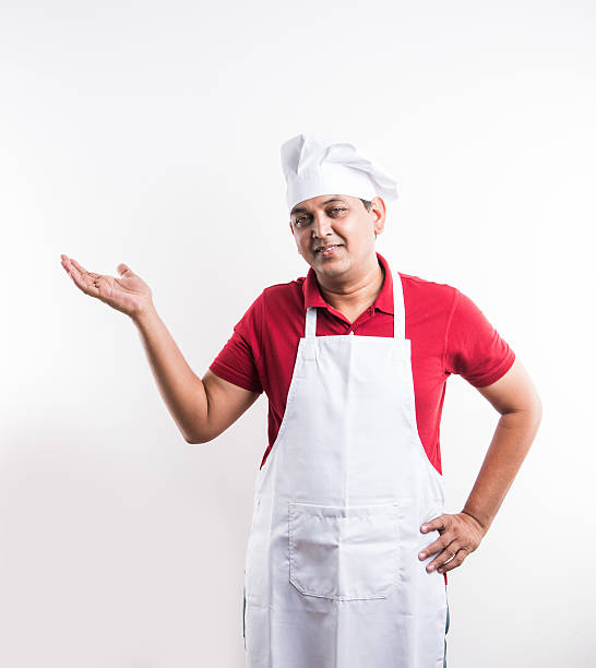 istock indian male chef presenting with hand gesture 576581322