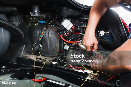 istock Electrician works with electric block in car 576582996