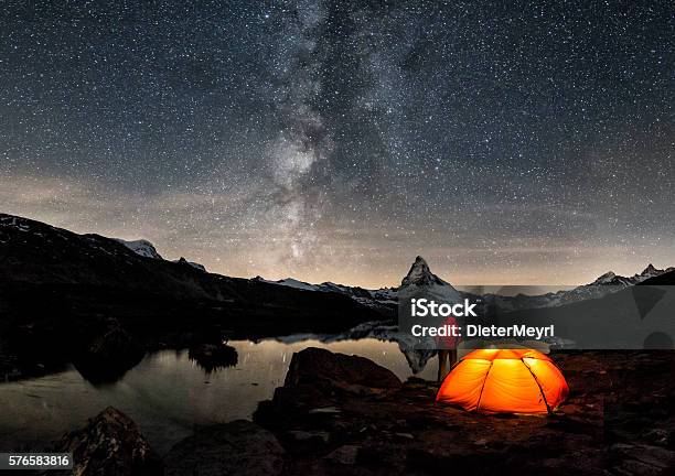 Loneley Camper Under Milky Way At Matterhorn Stock Photo - Download Image Now - Camping, Night, Star - Space