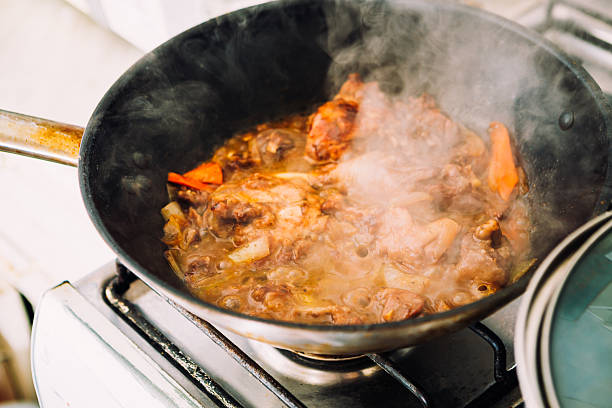 istock chicken in sauce with carrots on a pan closeup 576584332