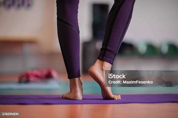 Woman Standing At Yoga Class Stock Photo - Download Image Now - Yoga, Barefoot, Close-up