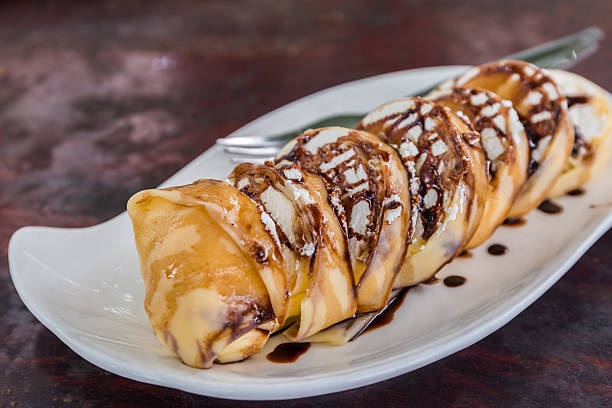 istock Banana crepe roll and with chocolate sauce. 576595436