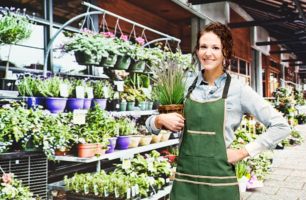 istock Smiling florist standing in flower shop 576595864