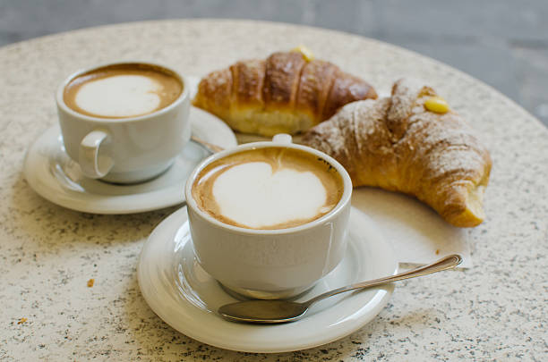 istock Two cups of cappuccino with two croissants. 576597674