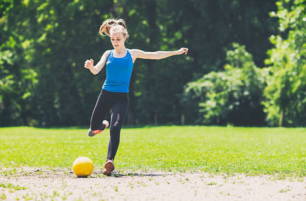 istock Woman playing soccer 576598346