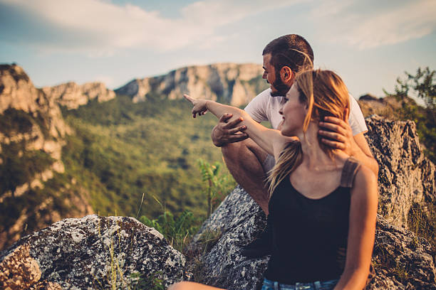 Man and woman on mountain adventure on a summer day.