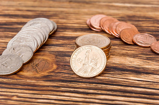 istock Dollar coins on wooben table 576599000